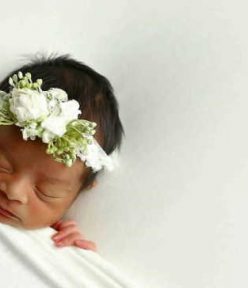 What should the photographer carry while they move for a newborn photoshoot?